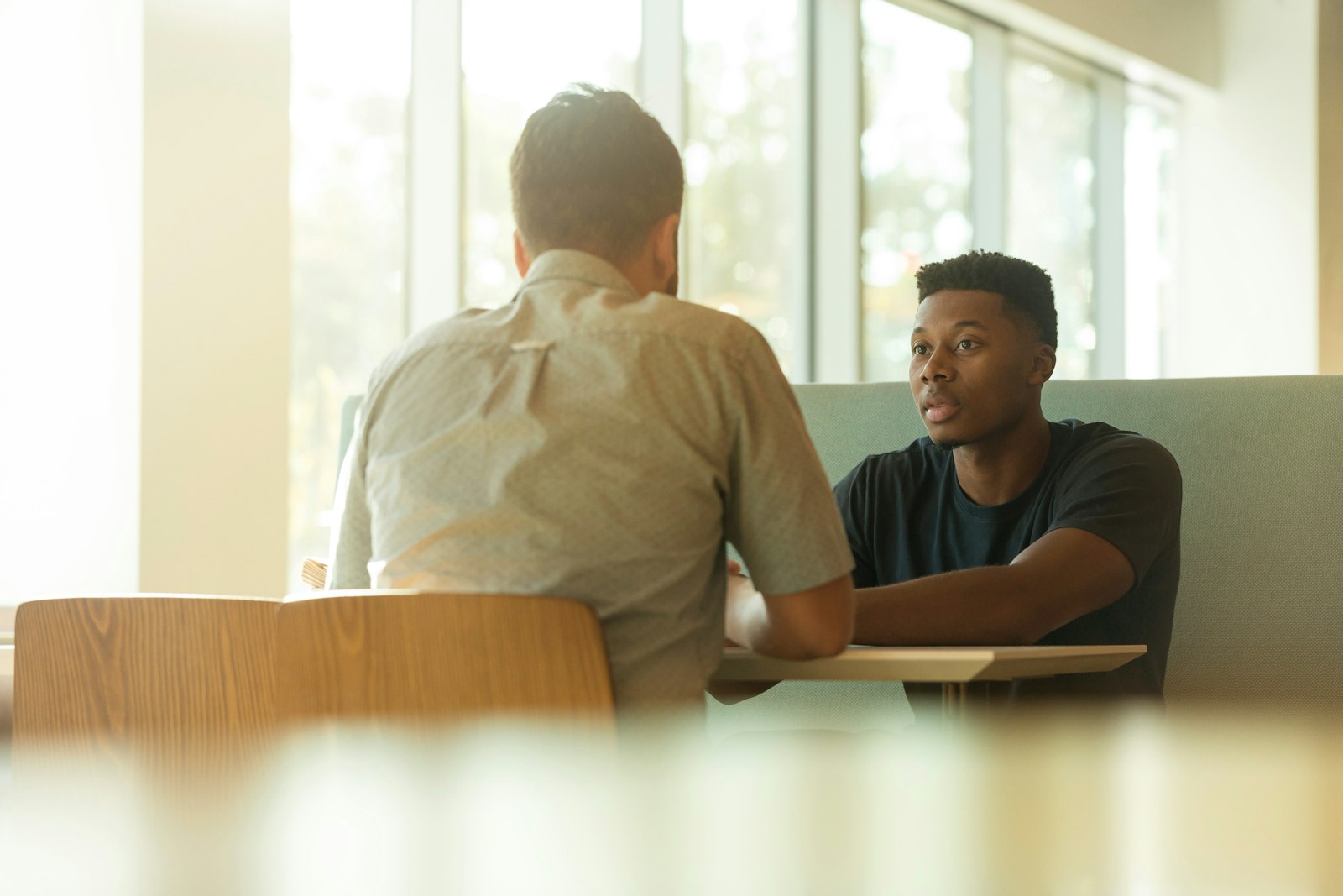 Zwei Männer im vertraulichen Gespräch im Büro während eines Executive Coaching