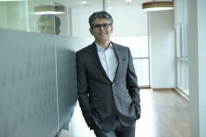 Manager im Anzug steht in einem Büroflur – Sinnbild für Interim-Management und Führung auf Zeit