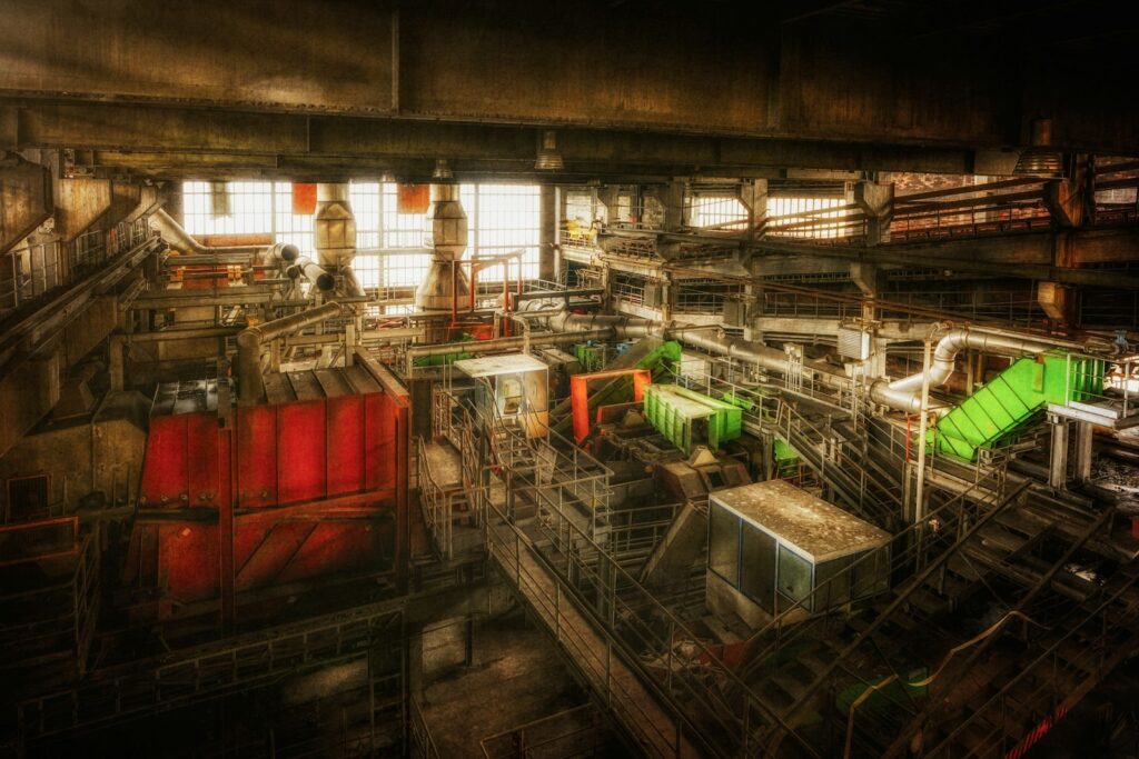 Rot-grüne Industriemaschine in einer Produktionshalle – Einsatzfeld für Interim-Management in der Industrie